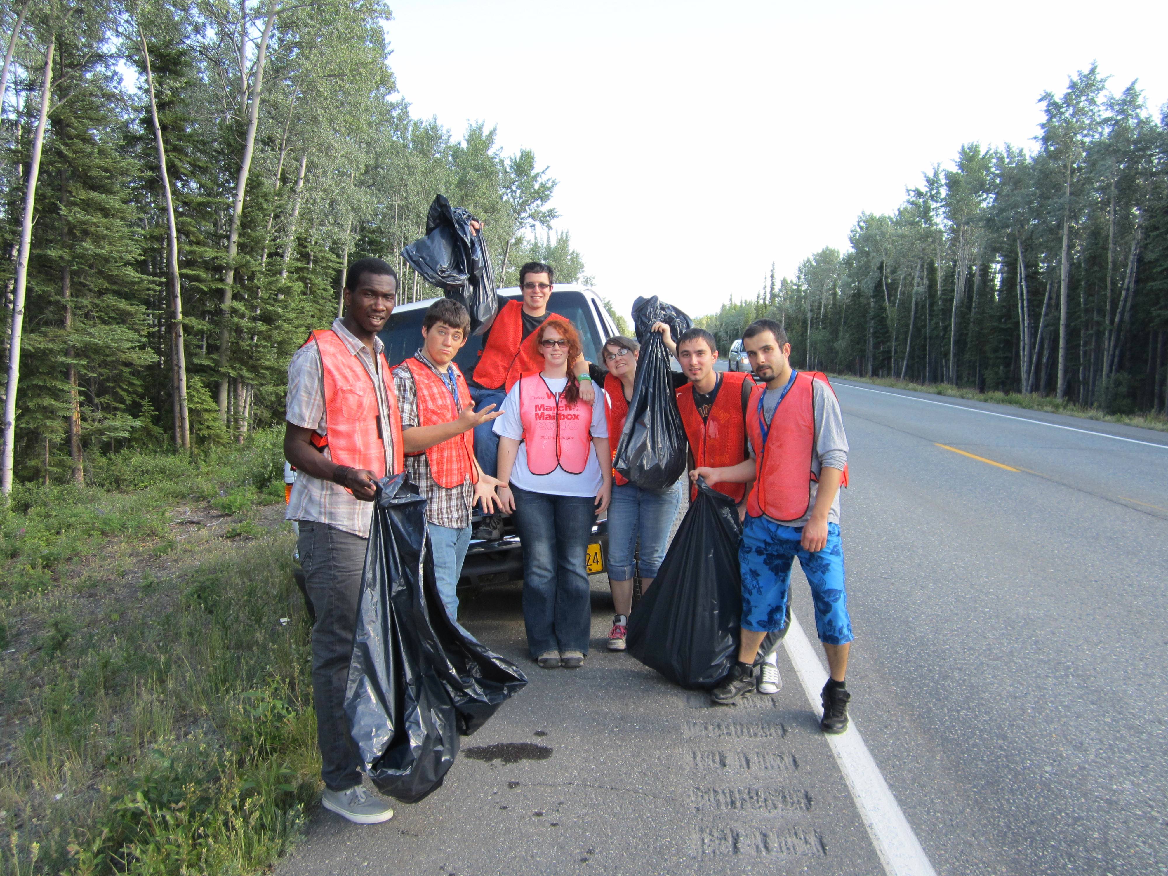 Lodge employees (left to right) David Jonas, Dustin Ward, Patrick Parriott, Sarah Lafferty, Jessica Weaver, Vadim Bizga and Ile Taneski show off bags of the trash they picked up. Photo courtesy Princess Lodges. Princess Lodges employees wearing orange vests pose for a photo on the shoulder of the highway