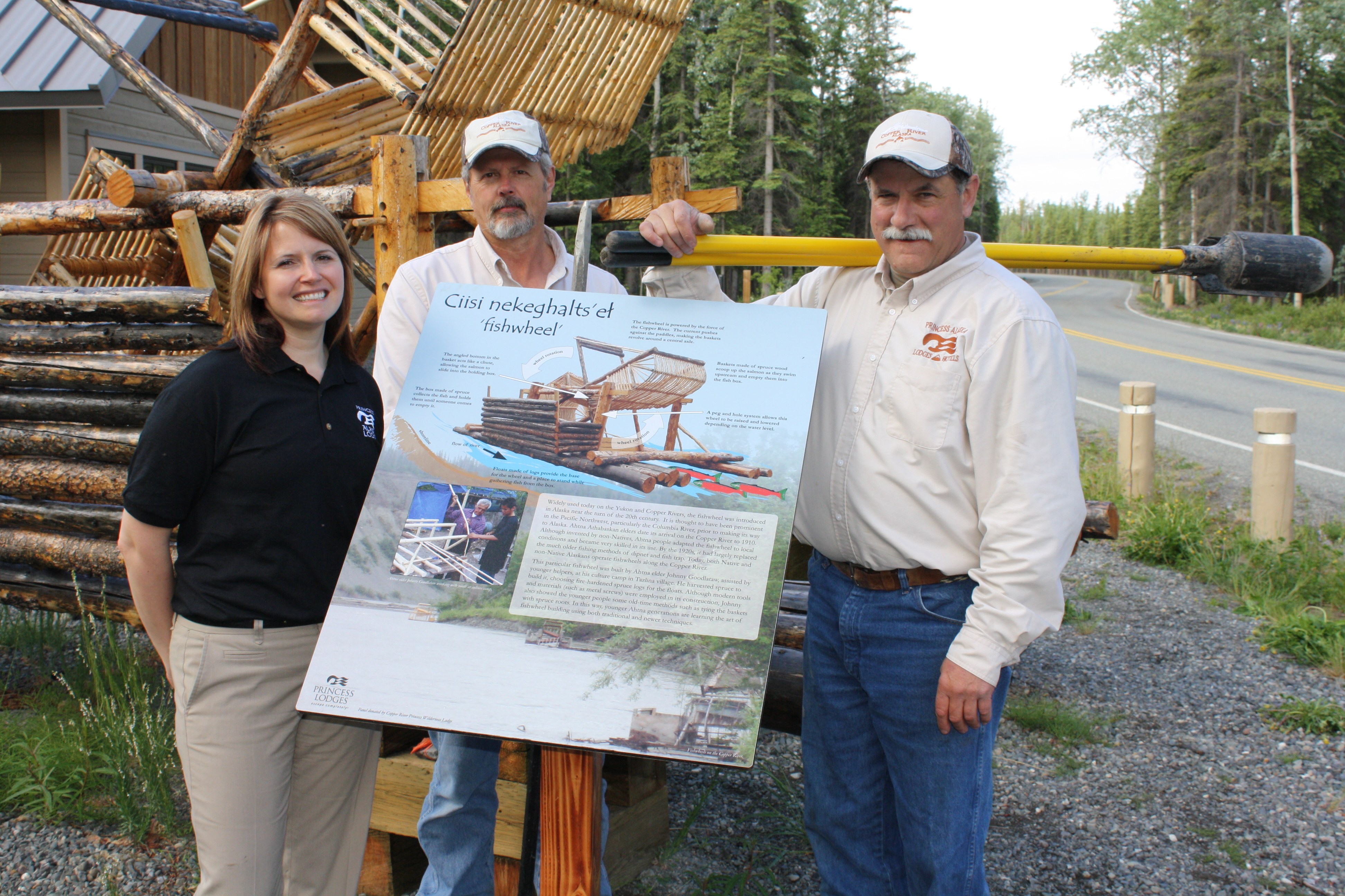 Tracy Smith, Copper River Princess Wilderness Lodge general manager, along with Gregory Sports and Bob Chase of the lodge's maintenance team in front of the new sign and fish wheel. Photo courtesy Princess Lodges. Tracy Smith, Copper River Princess Wilderness Lodge general manager, along with Gregory Sports and Bob Chase of the lodge's maintenance team in front of the new sign and fish wheel.