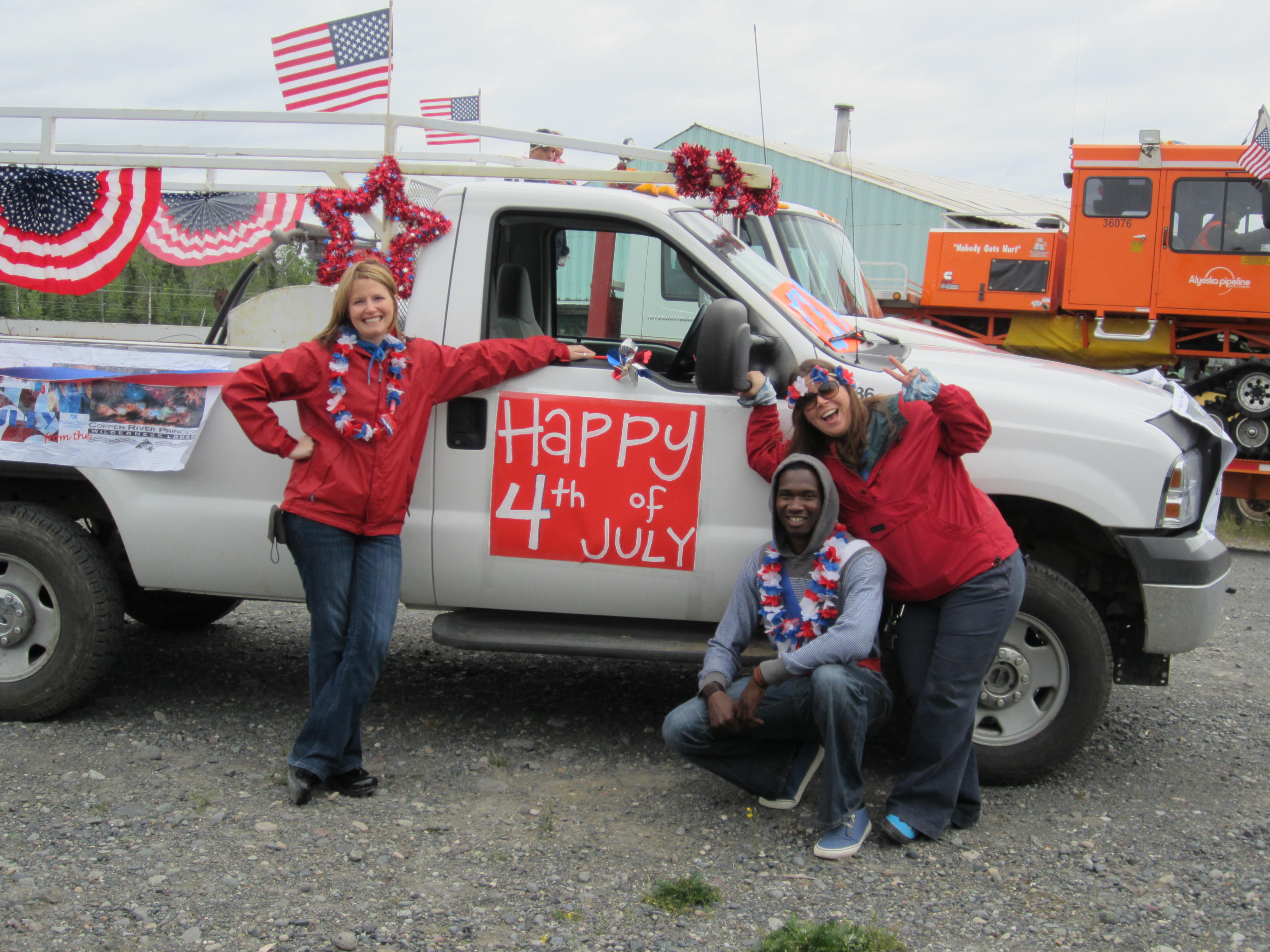Copper River Princess Wilderness Lodge employees (left to right) Tracy Smith, general manager, David Jonas and Rebecca Martz. Photo courtesy Princess Lodges. More employees posing with the red white and blue decorated truck for the Fourth of July Parade.